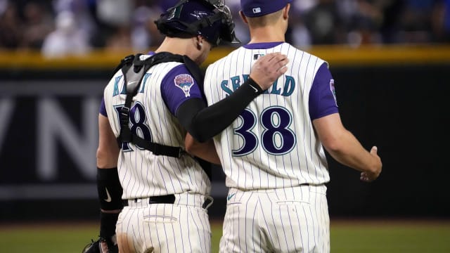 Carson Kelly and Paul Sewald celebrate a win after Sewald earns a save on August 12th, 2023